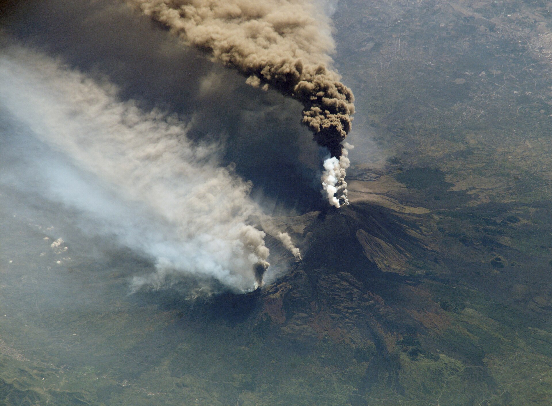 Mount Etna volcanic slopes and lava fields above Eastern Sicily